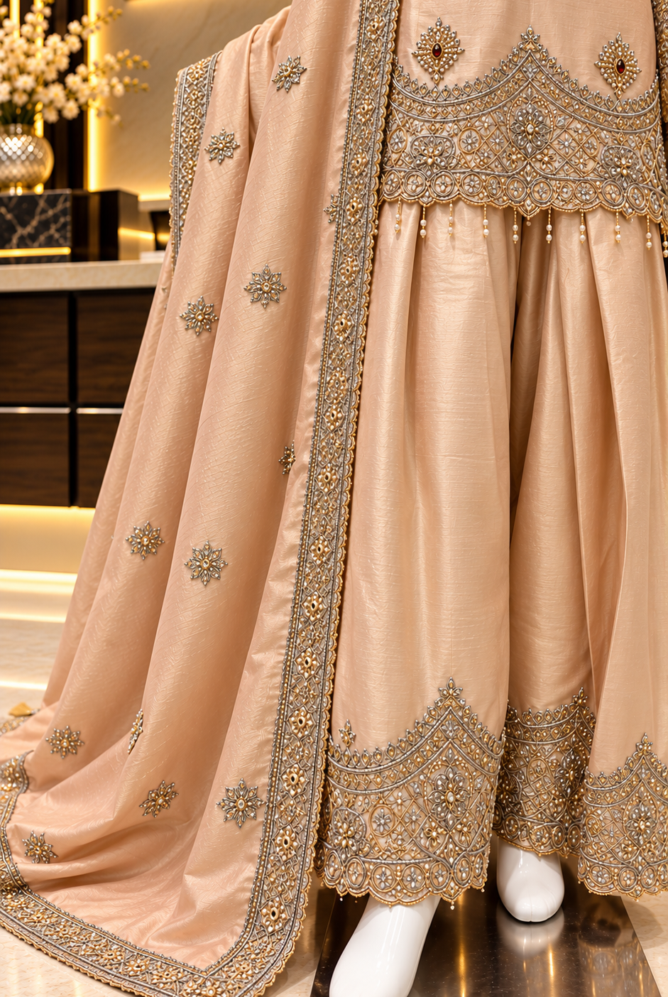 Light peach farshi salwar with embroidered hem border and buti dupatta