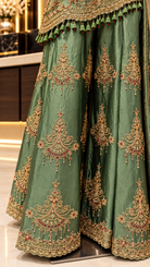 Sage green palazzo pants with embroidered motifs and scalloped border